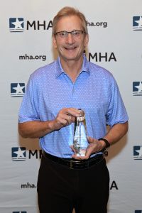 Greg Lane, executive vice president and chief administrative officer, McLaren Health Care, receives the Ludwig Award on behalf of McLaren Bay Region and its foundation opened the Helen M. Nickless Volunteer Clinic.